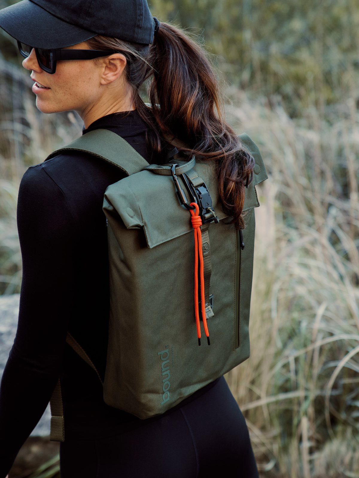 Green Bound Roll-Top Backpack worn outdoors