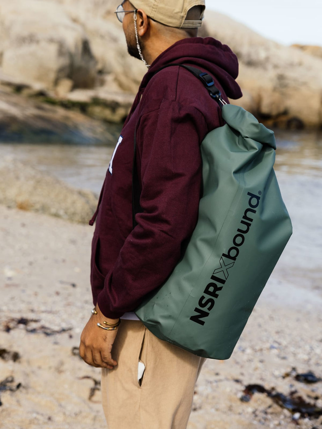 NSRI x Bound waterproof roll-top backpack worn at the beach