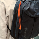 City Backpack Duffel in black close-up of the top handle, side zip and orange pull cord