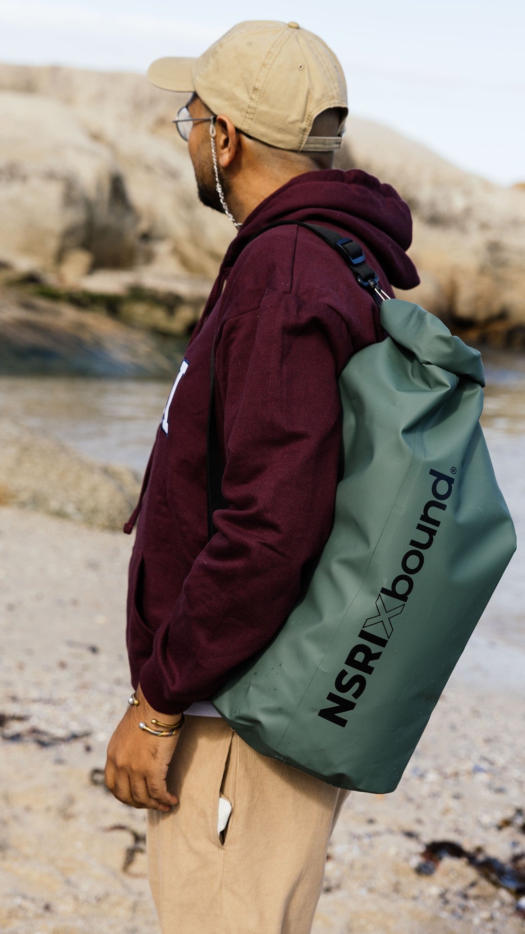 NSRI x Bound waterproof roll-top backpack worn at the beach
