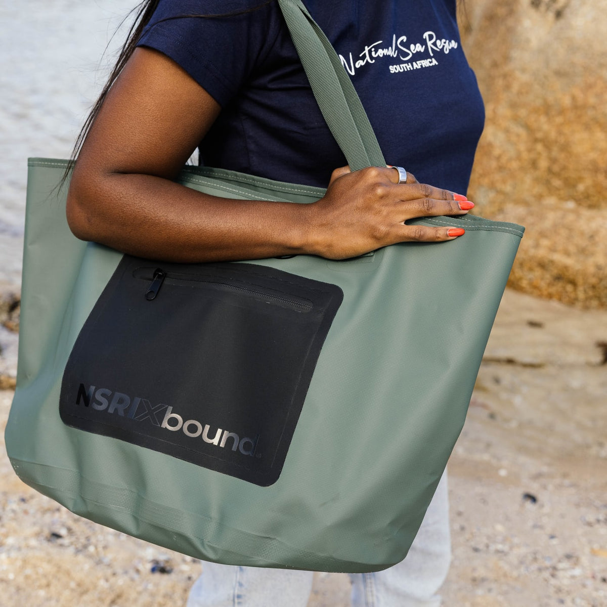 NSRI x Bound waterproof tote carried on the beach