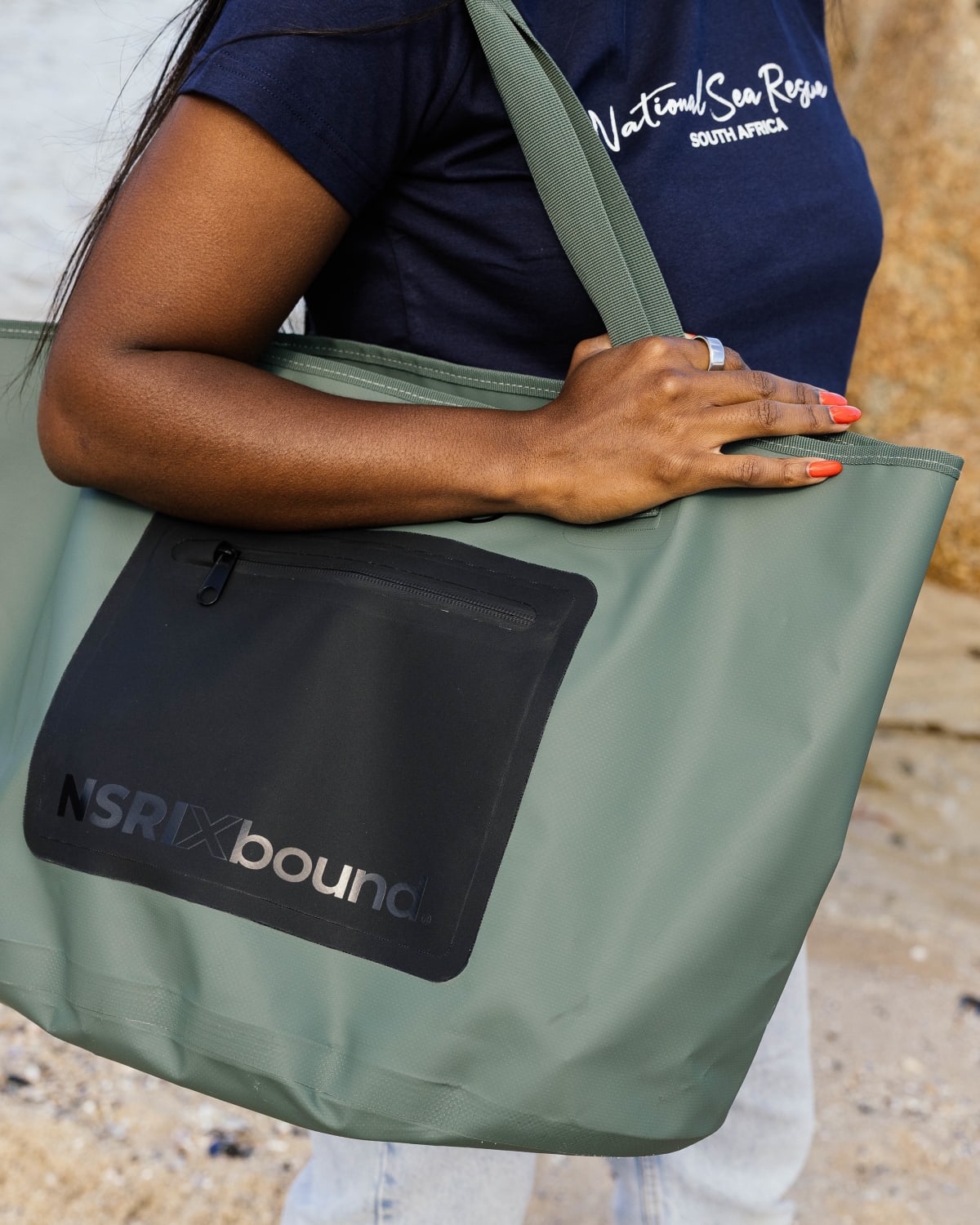 Sea Rescue volunteer with the NSRI x Bound waterproof tote, portrait crop